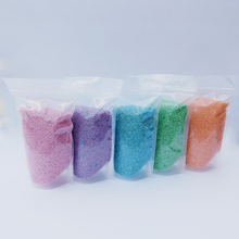 Load image into Gallery viewer, Five bags of colorful sensory play rice bin filler pink, purple, blue, green, orange.