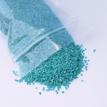 Load image into Gallery viewer, Spilling bag of colorful sensory play rice bin filler blue detail
