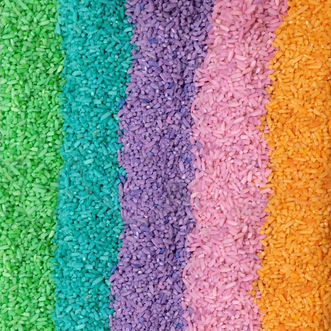Colorful sensory play rice bin filler detail: green, blue, purple, pink, and orange.